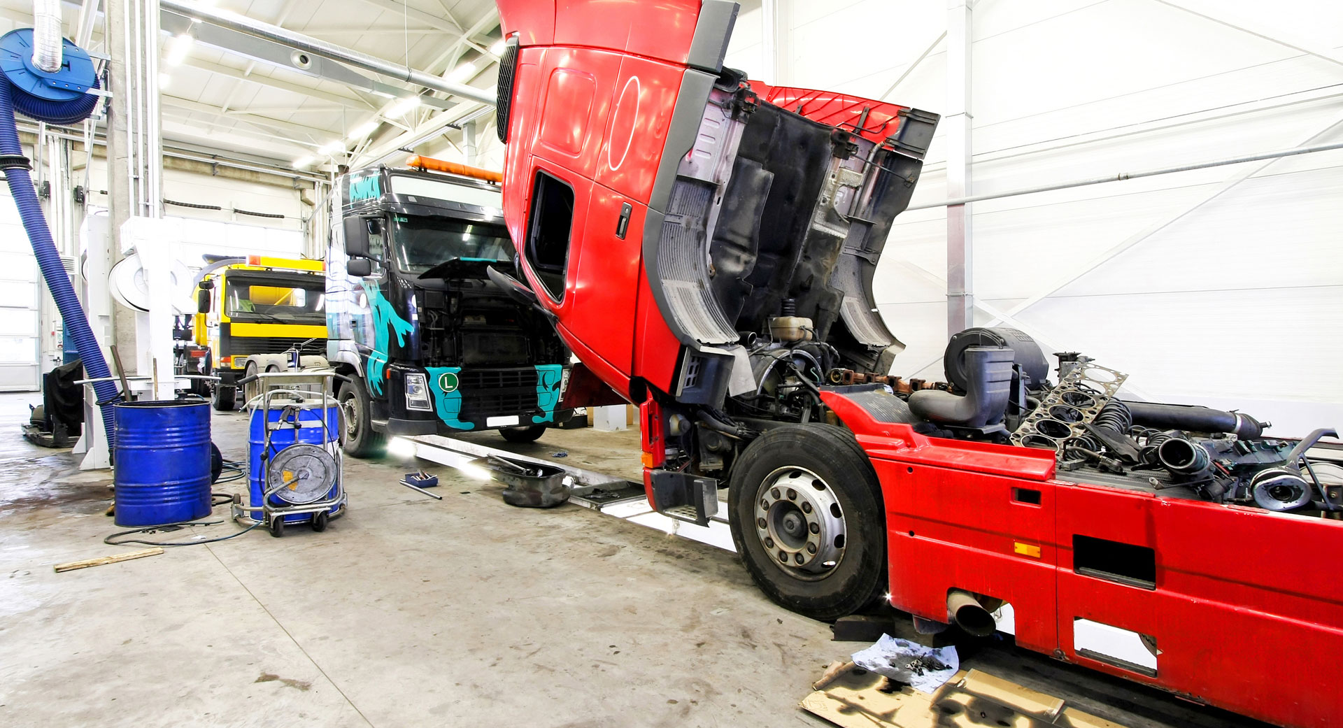 truck with engine popped open in repair shop